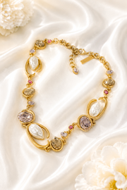Baroque-inspired light pink rhinestone-style necklace on cream satin