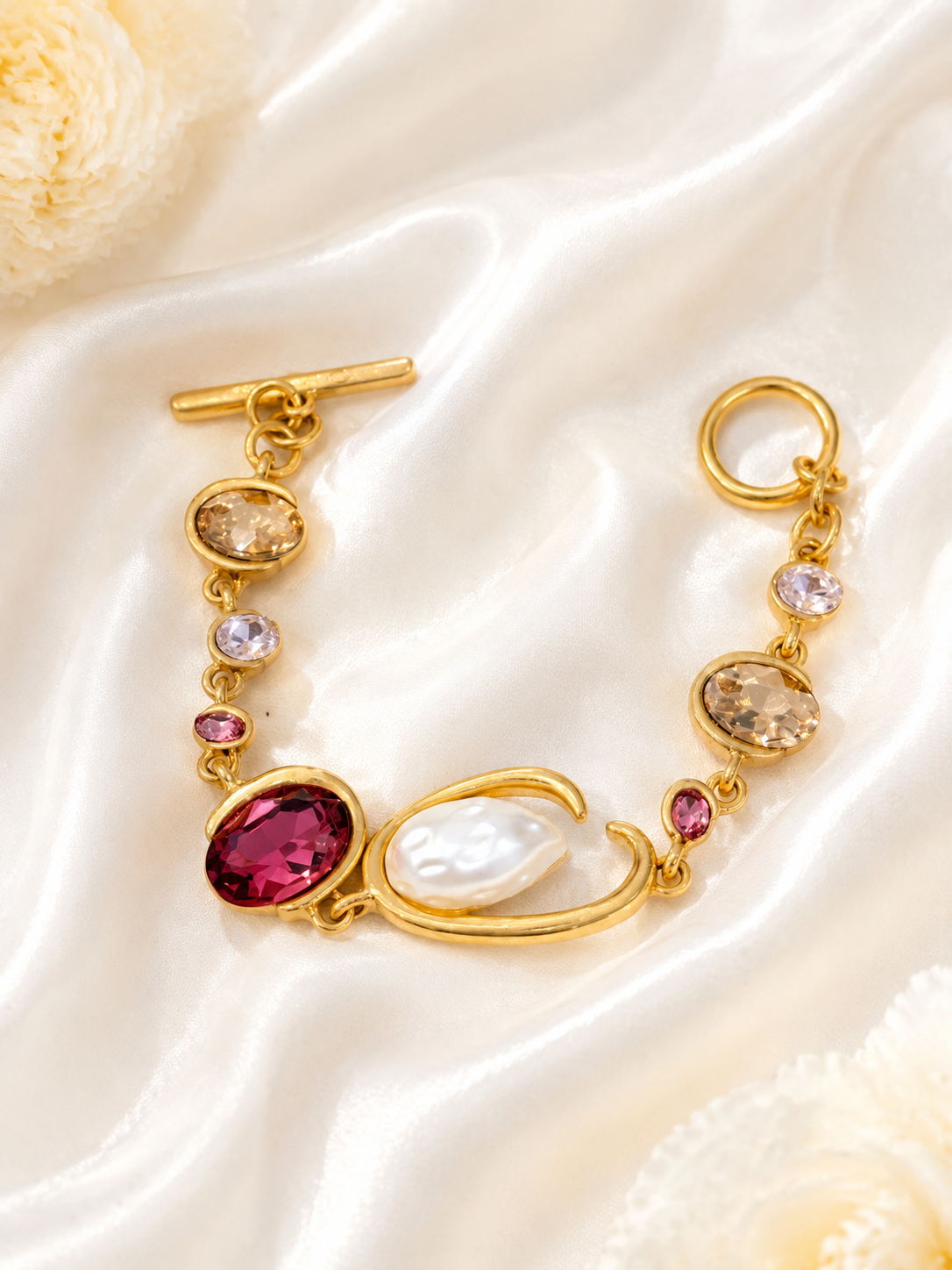 Baroque-inspired magenta rhinestone-style bracelet on cream satin