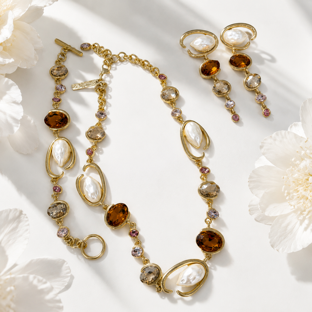 Baroque-inspired orange rhinestone and pearl-style jewelry collection with necklace bracelet and stud earrings