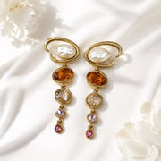 Baroque-inspired orange rhinestone and pearl-style stud earrings