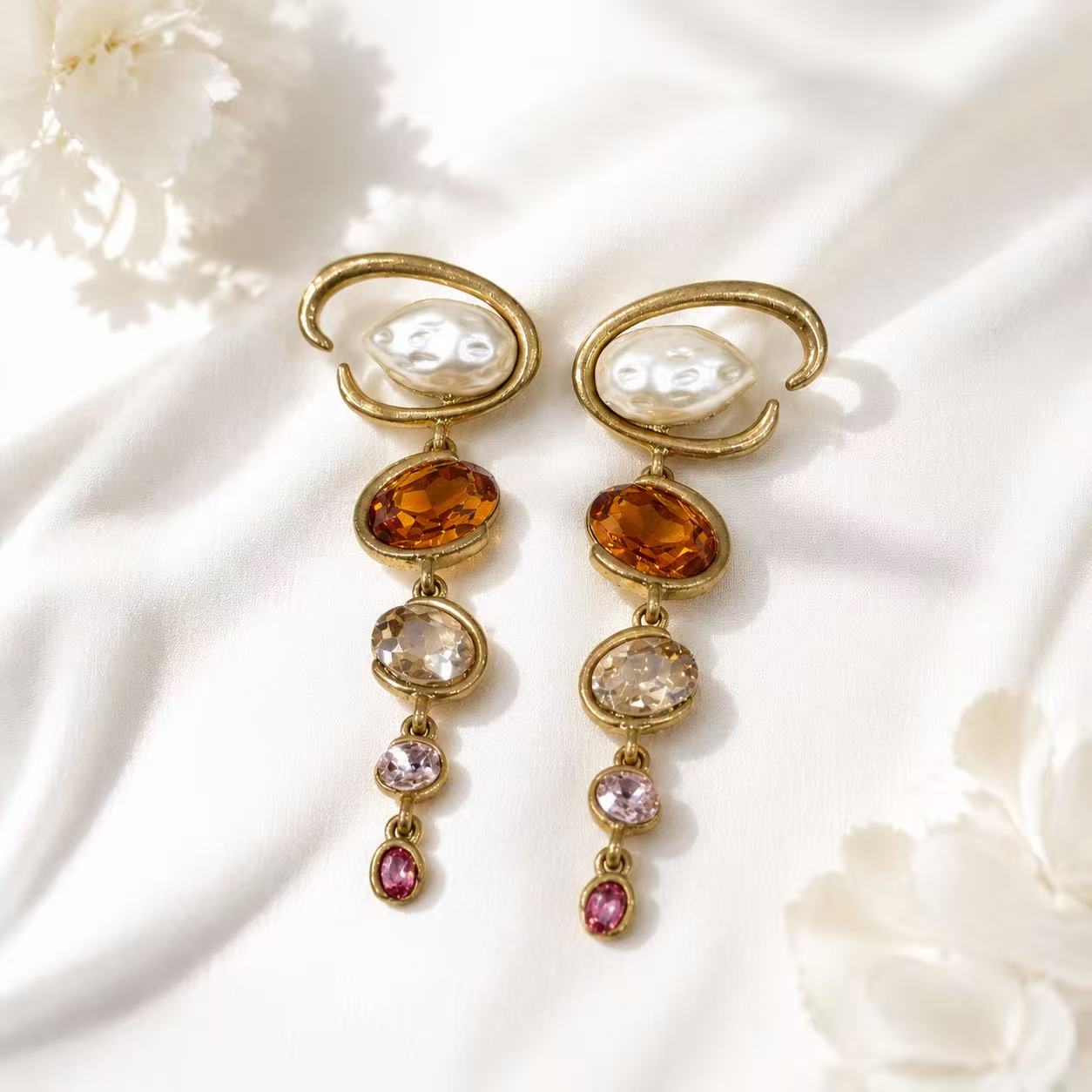 Baroque-inspired orange rhinestone and pearl-style stud earrings