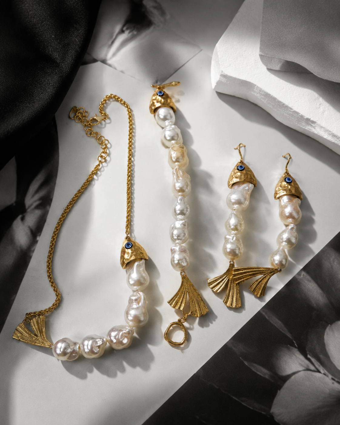 Gold-tone pearl-style jewelry set with blue details and fan-shaped charms