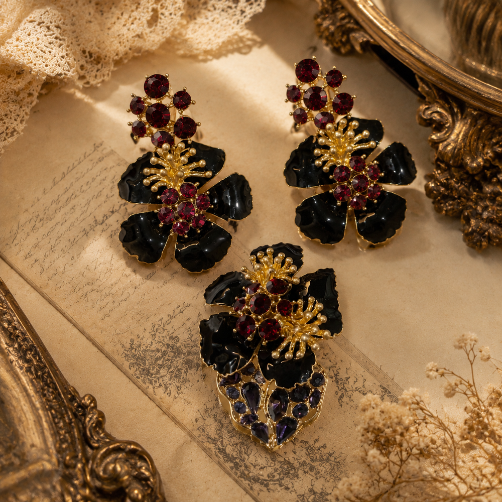 Black enamel-style ruby-red crystal-style brooch set front view with gold-tone floral details