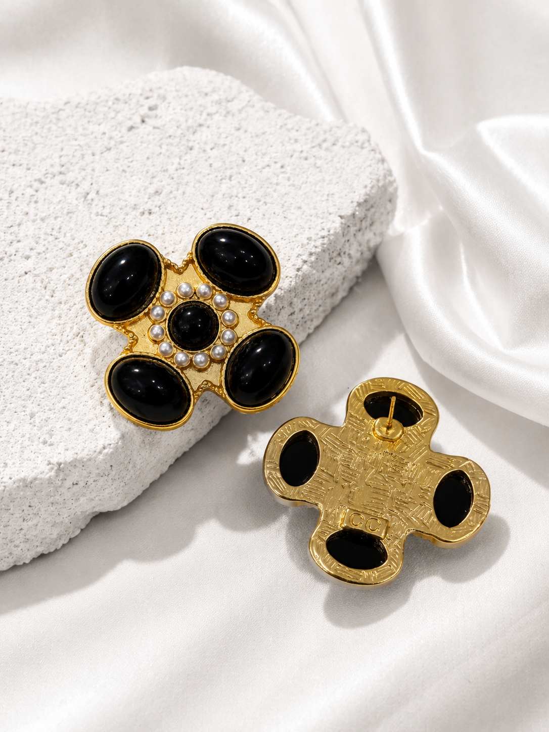 Black floral cross-inspired statement stud earrings, detail view