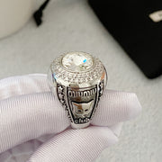 Side detail of silver-tone cat motif ring with clear faceted center accent