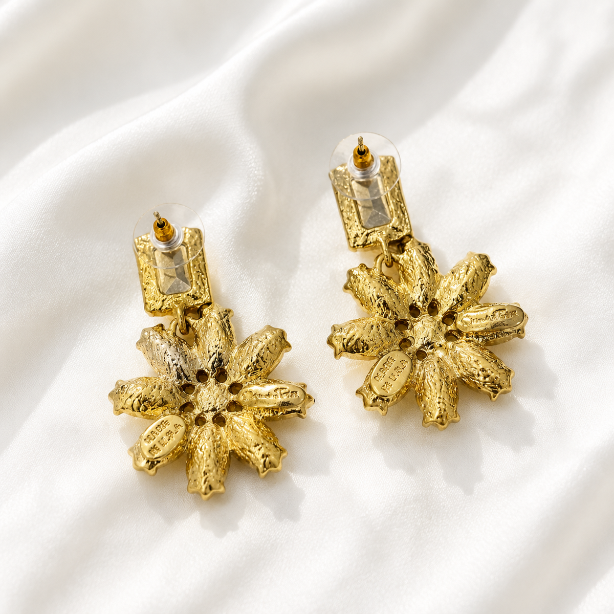 Back view of champagne crystal-style flower statement earrings showing post backs