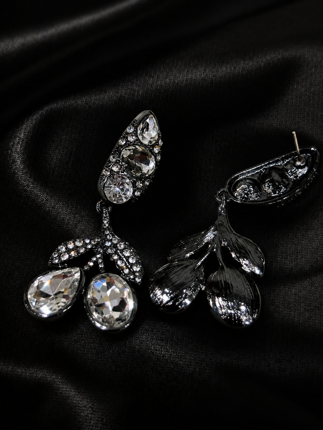 Clear crystal-style drop earrings with faceted accents, front and back view