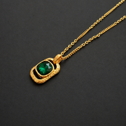 Green faceted glass cube pendant necklace, close view