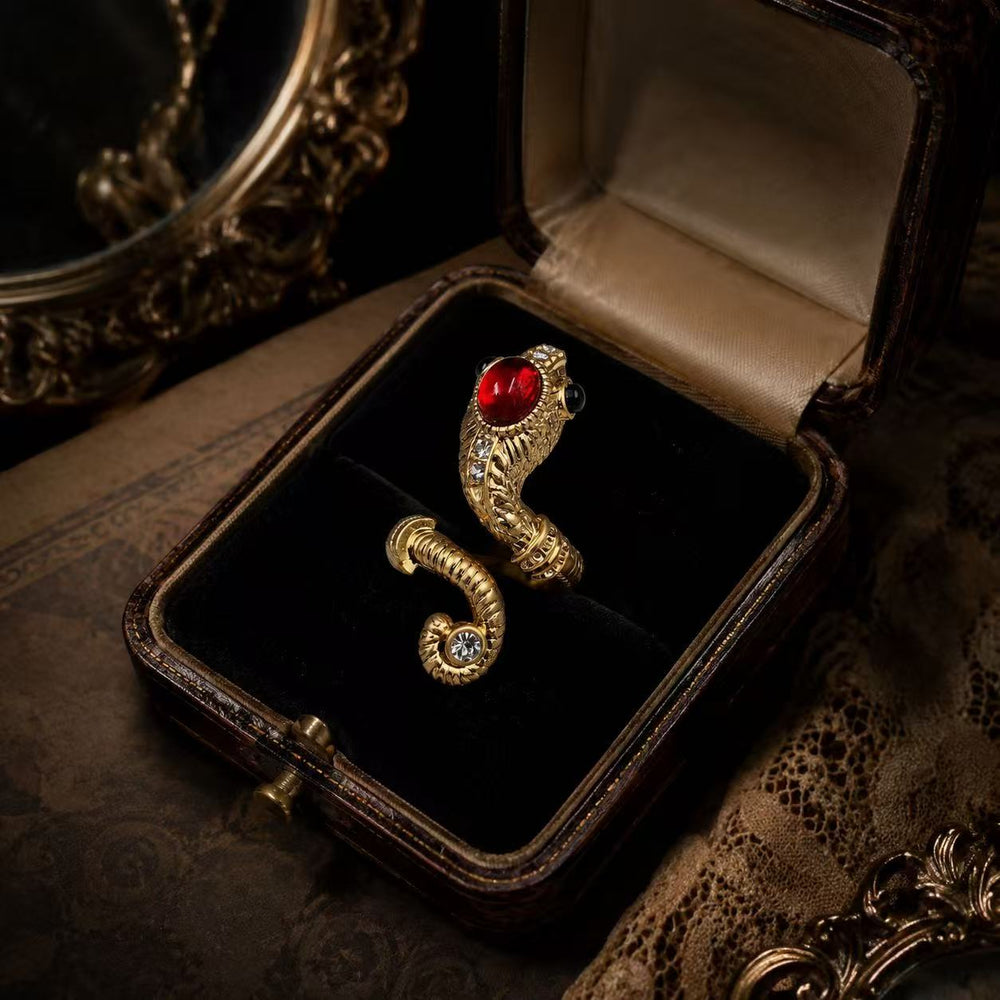 Gold-tone adjustable ring with red glass cabochon-style centerpiece in vintage jewelry box