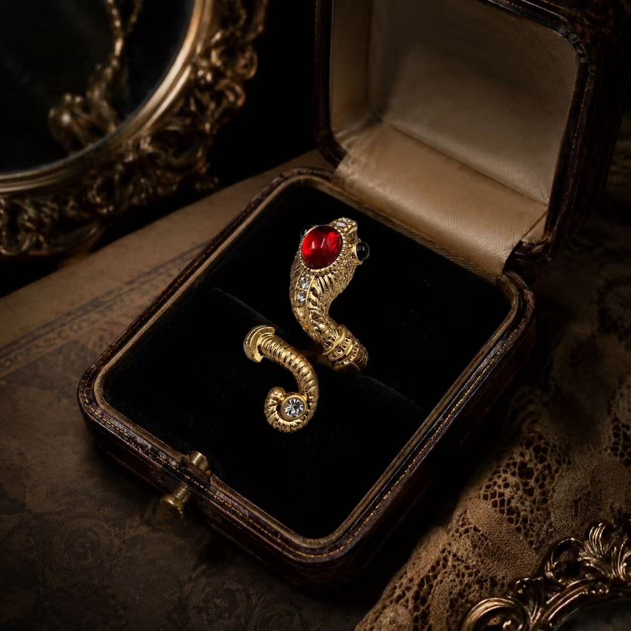 Gold-tone adjustable ring with red glass cabochon-style centerpiece in vintage jewelry box