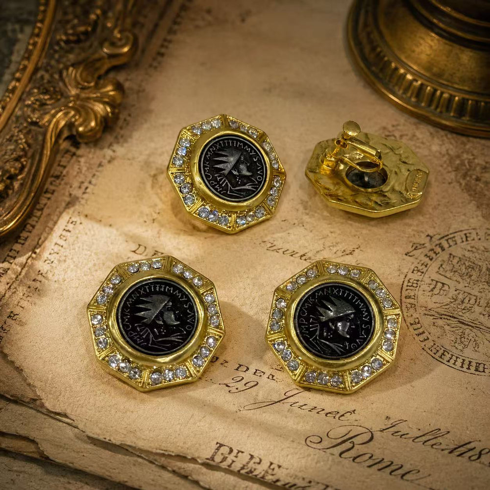 Gold-tone black coin-style stud and clip-on earrings front view