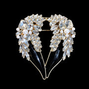 Gold-tone black crystal-style winged heart statement brooch front view