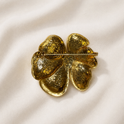 Gold-tone black enamel-style flower brooch back pin detail