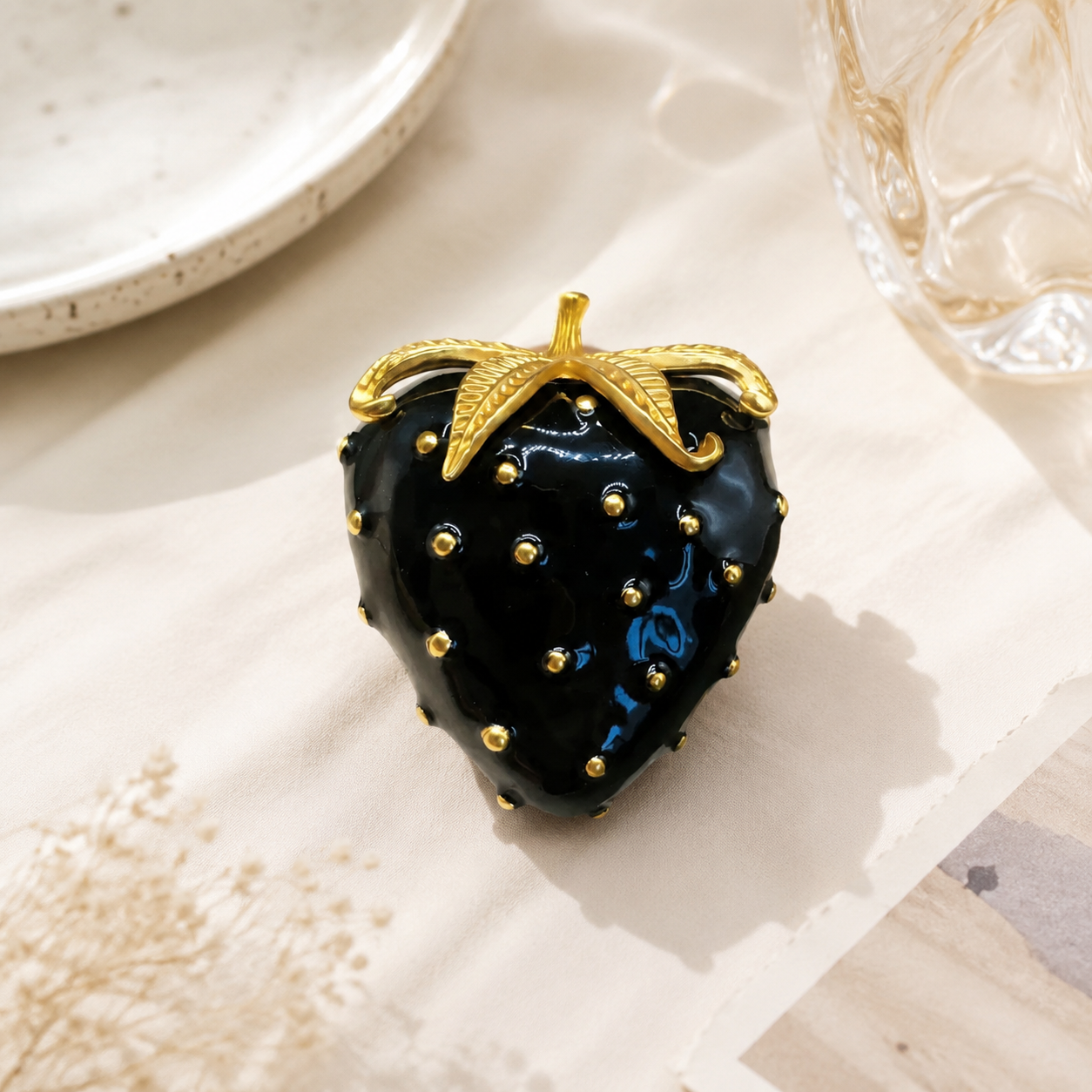 Gold-tone black enamel-style strawberry brooch front view