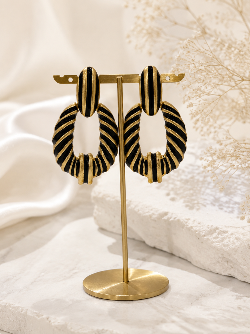 Gold-tone black enamel-style zebra stripe statement earrings front view