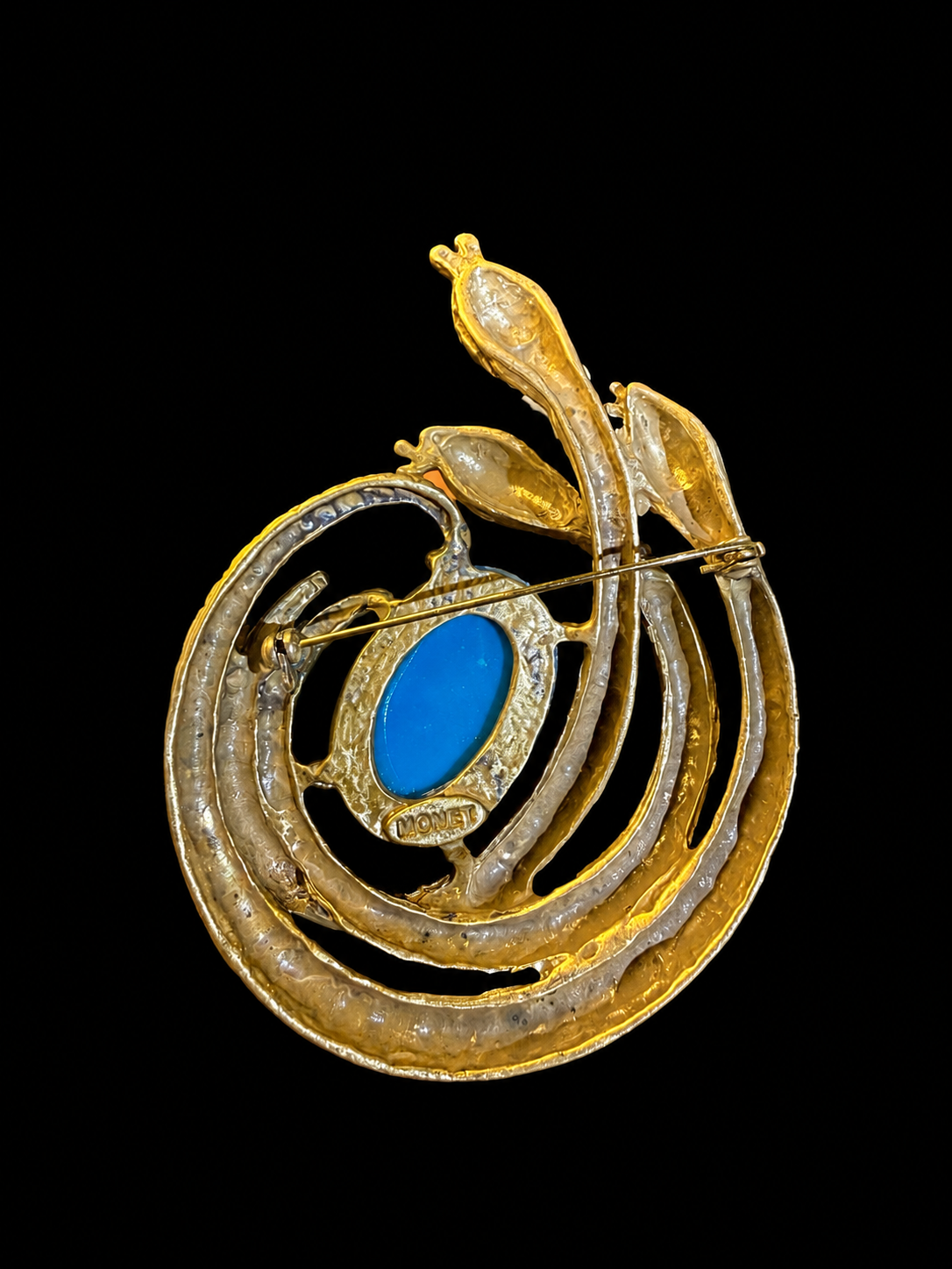 Gold-tone blue cabochon-style serpent statement brooch back view showing pin clasp
