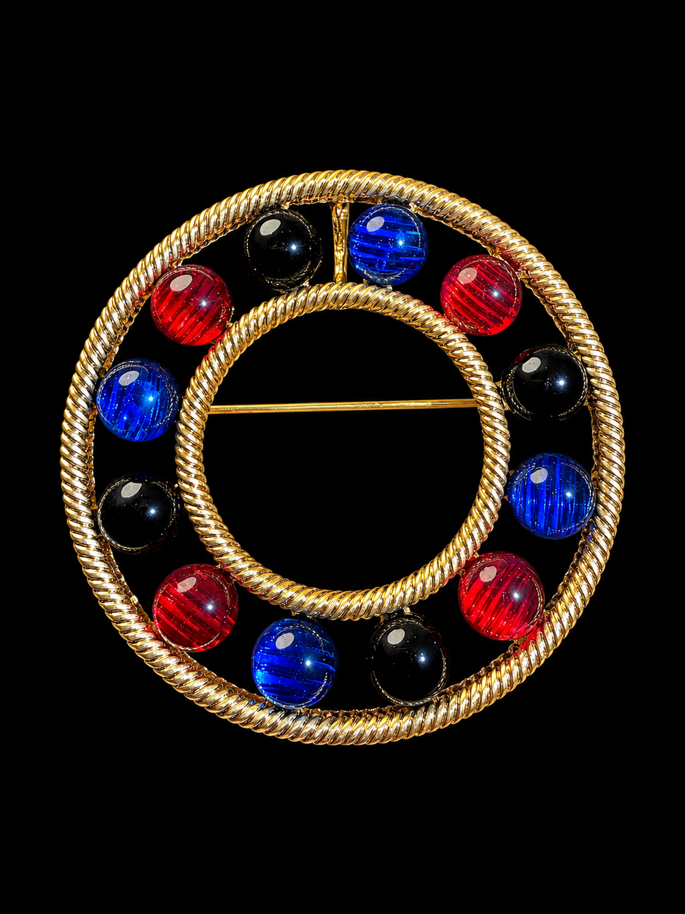 Gold-tone convertible circle cabochon-style brooch pendant front view with red blue and black accents