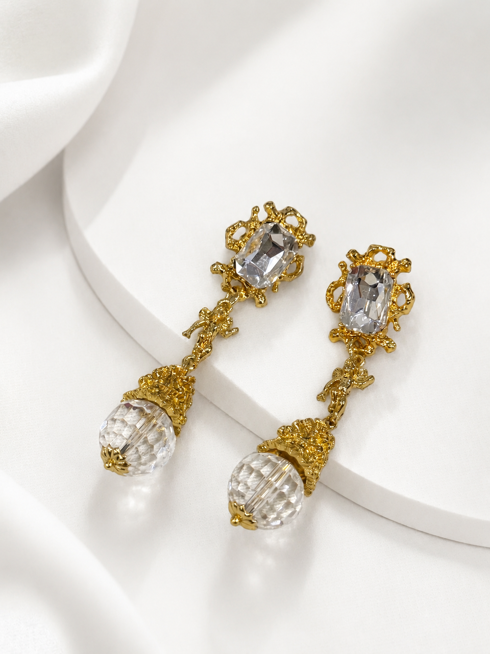 Pair of gold-tone crystal glass angel pendant drop stud earrings with clear faceted drops