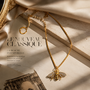 Gold-tone clear crystal accent bee pendant necklace editorial flat lay