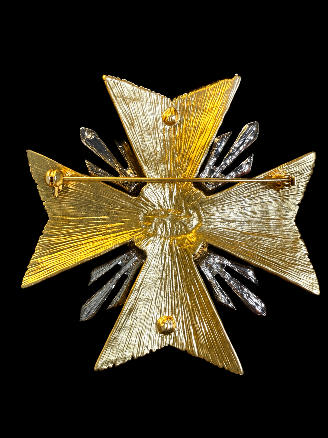 Back view of gold-tone cross statement brooch with pin closure