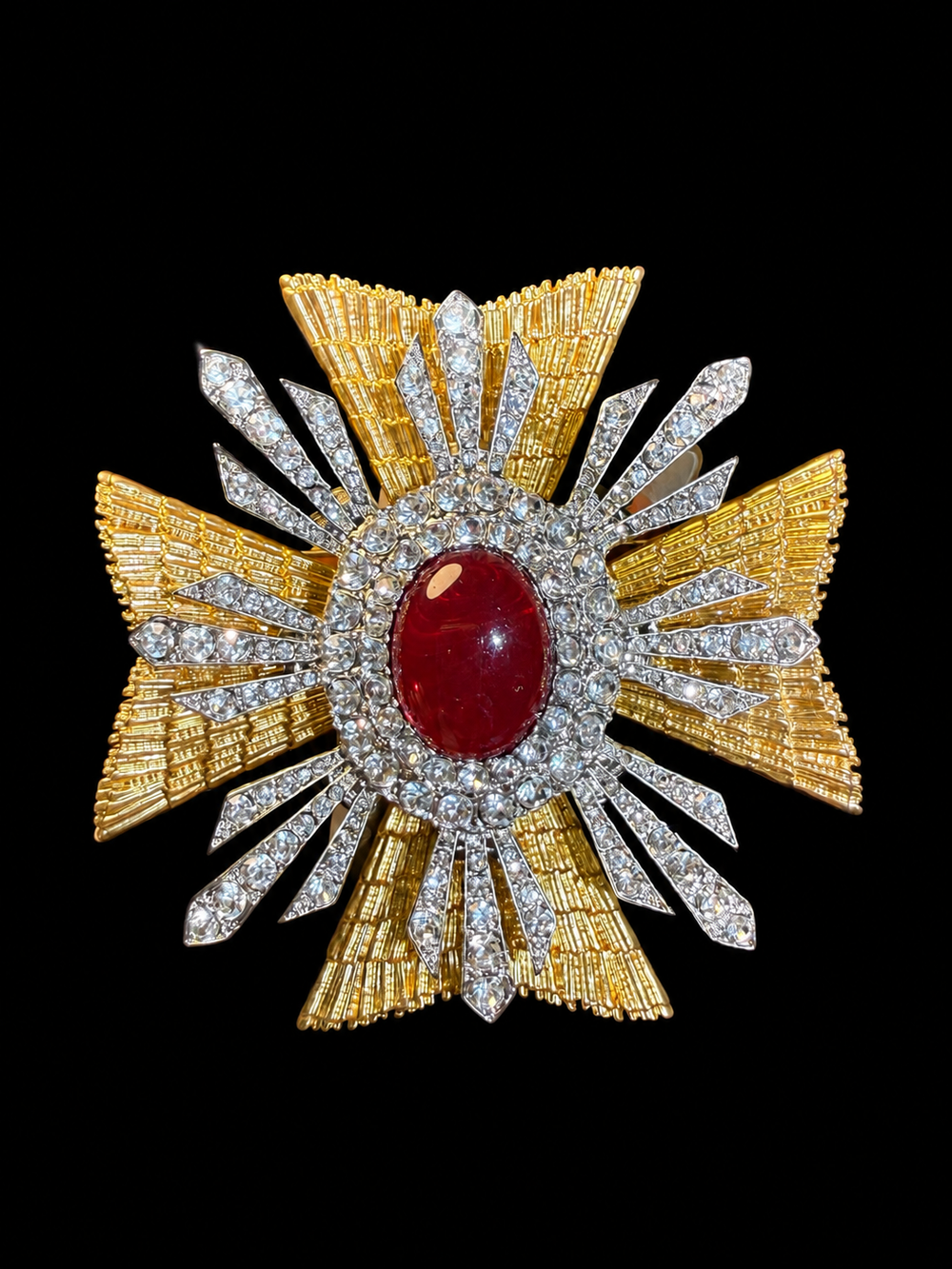 Gold-tone crystal-style cross statement brooch with red cabochon-style center front view