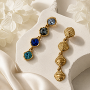 Front and back view of blue gold-tone crystal-style drop stud earrings