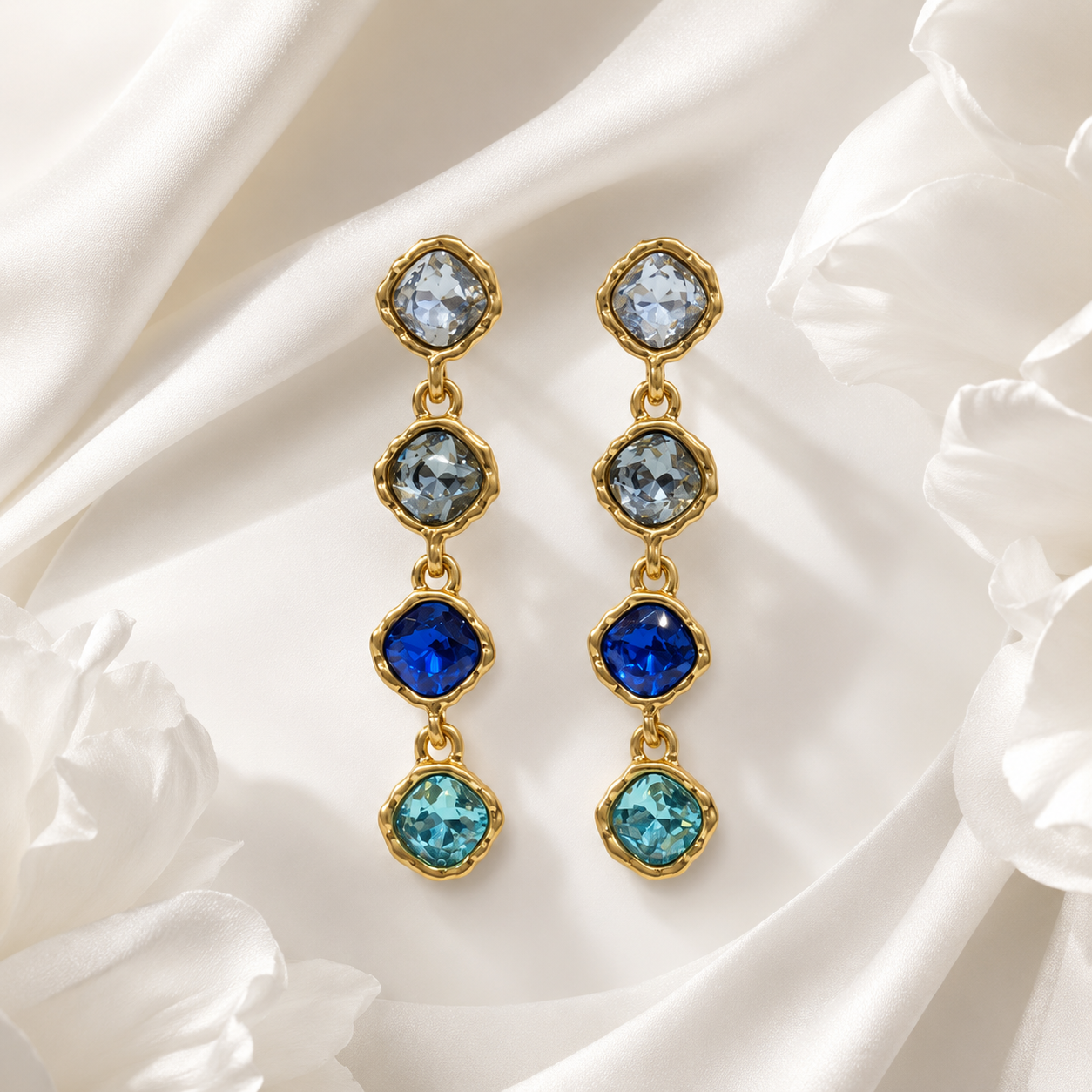 Blue gold-tone crystal-style four-stone drop stud earrings