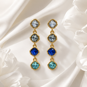 Blue gold-tone crystal-style four-stone drop stud earrings