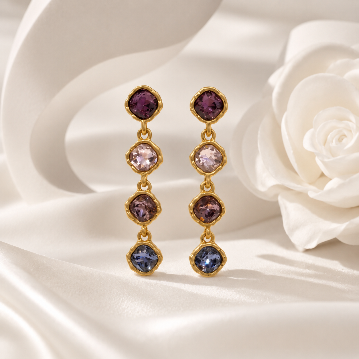 Purple gold-tone crystal-style four-stone drop stud earrings