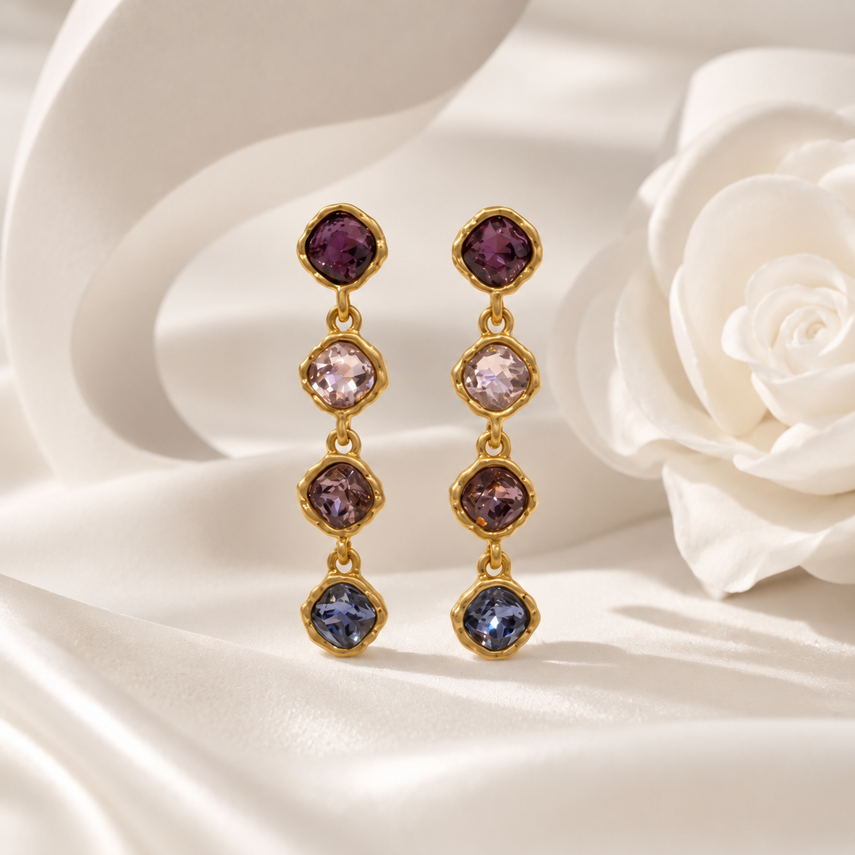 Purple gold-tone crystal-style four-stone drop stud earrings