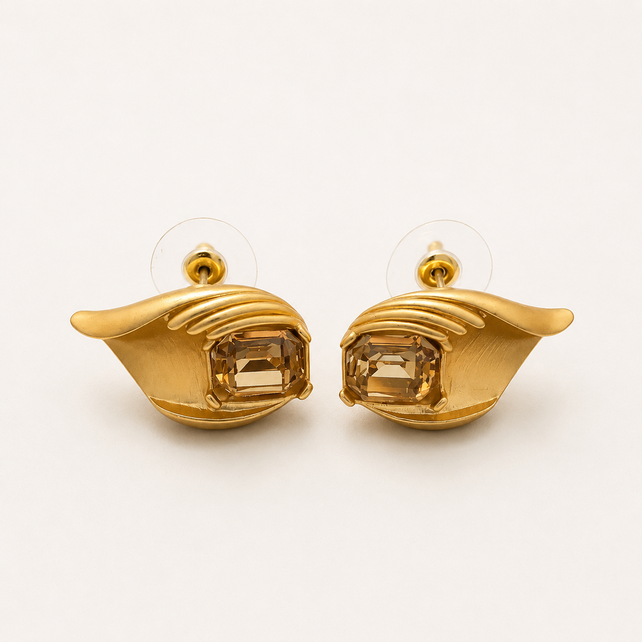 Gold-tone champagne crystal-style leaf stud earrings pair