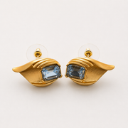 Gold-tone light blue crystal-style leaf stud earrings pair