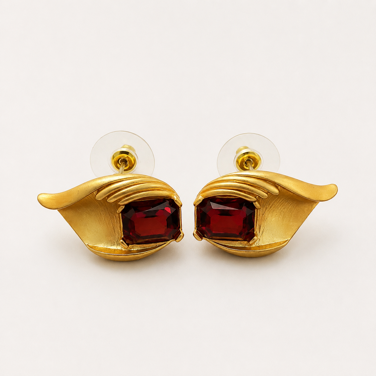 Gold-tone wine red crystal-style leaf stud earrings pair