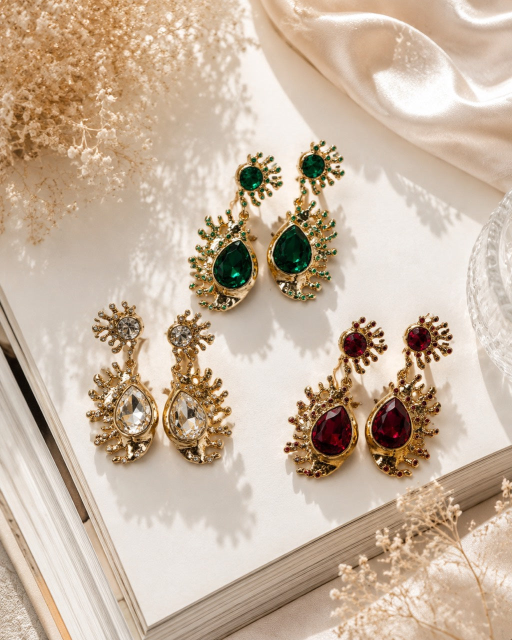Gold-tone crystal-style teardrop statement stud earrings in green clear and red color options
