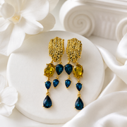 Blue crystal-style teardrop tassel earrings with gold-tone textured tops