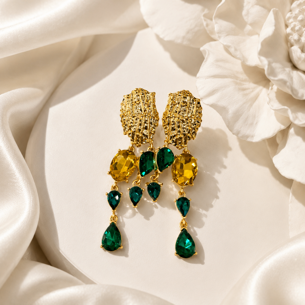 Green crystal-style teardrop tassel earrings with gold-tone textured tops