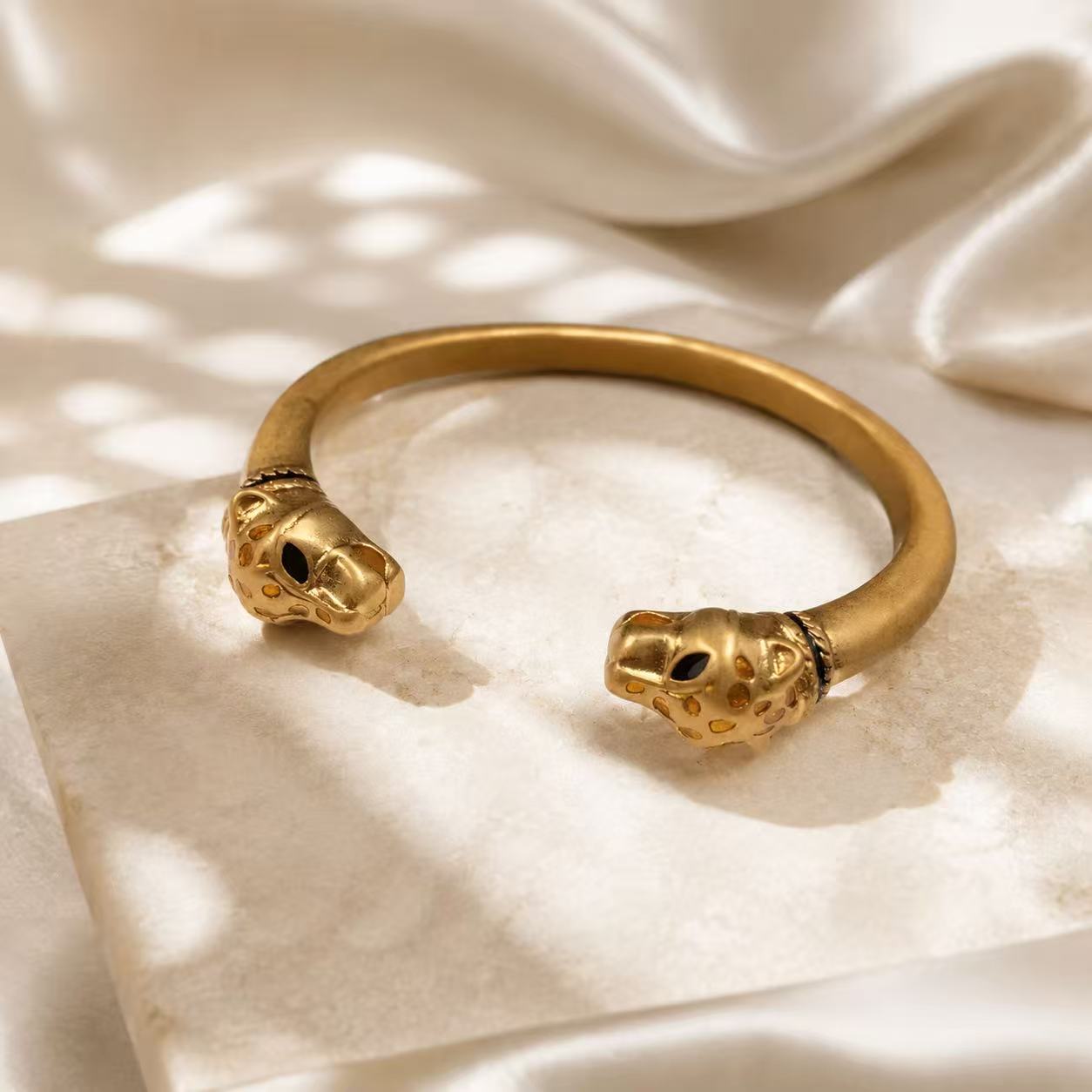 Gold-tone double leopard head open cuff bracelet front view
