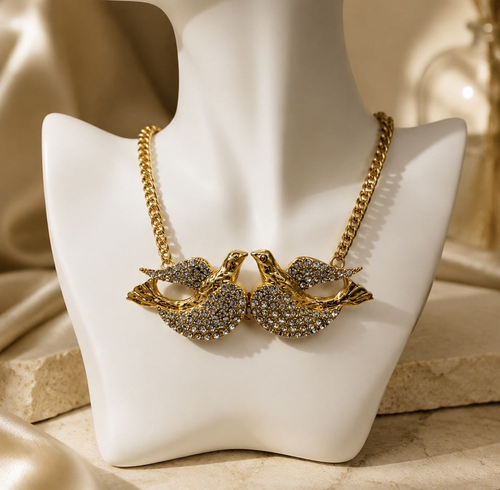 Gold-tone dove motif necklace with paired bird pendant