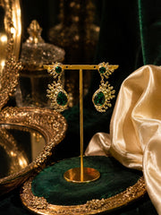 Gold-tone emerald green crystal-style teardrop stud earrings on display stand