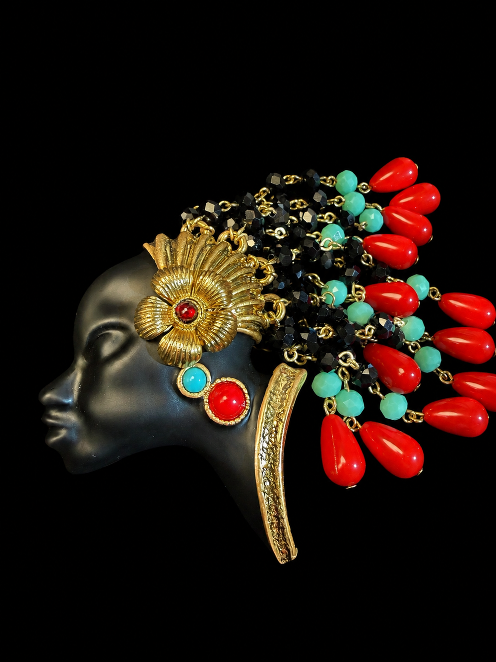 Gold-tone face tassel enamel-style resin bead brooch with red and turquoise accents front view