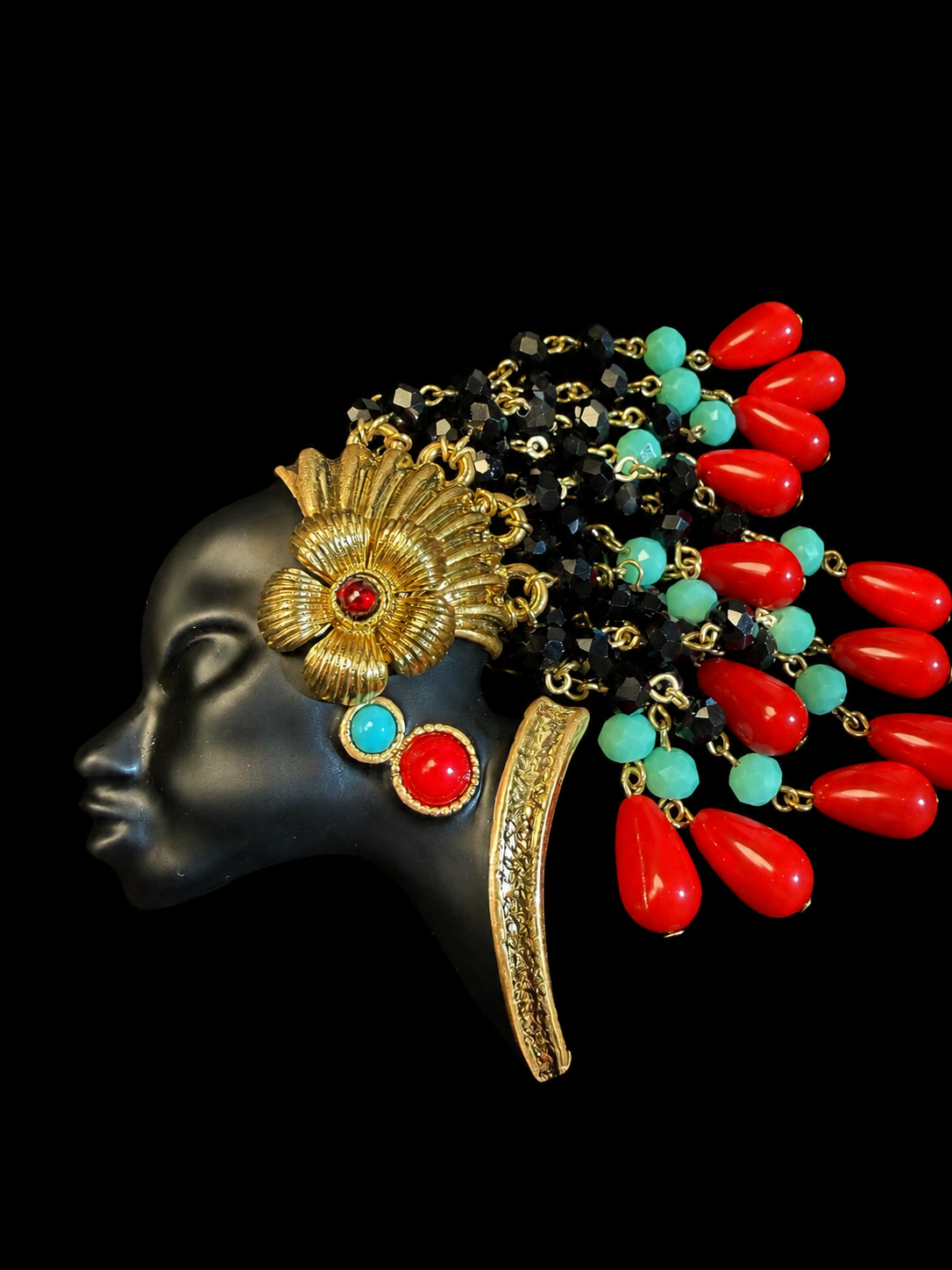 Gold-tone face tassel enamel-style resin bead brooch with red and turquoise accents front view
