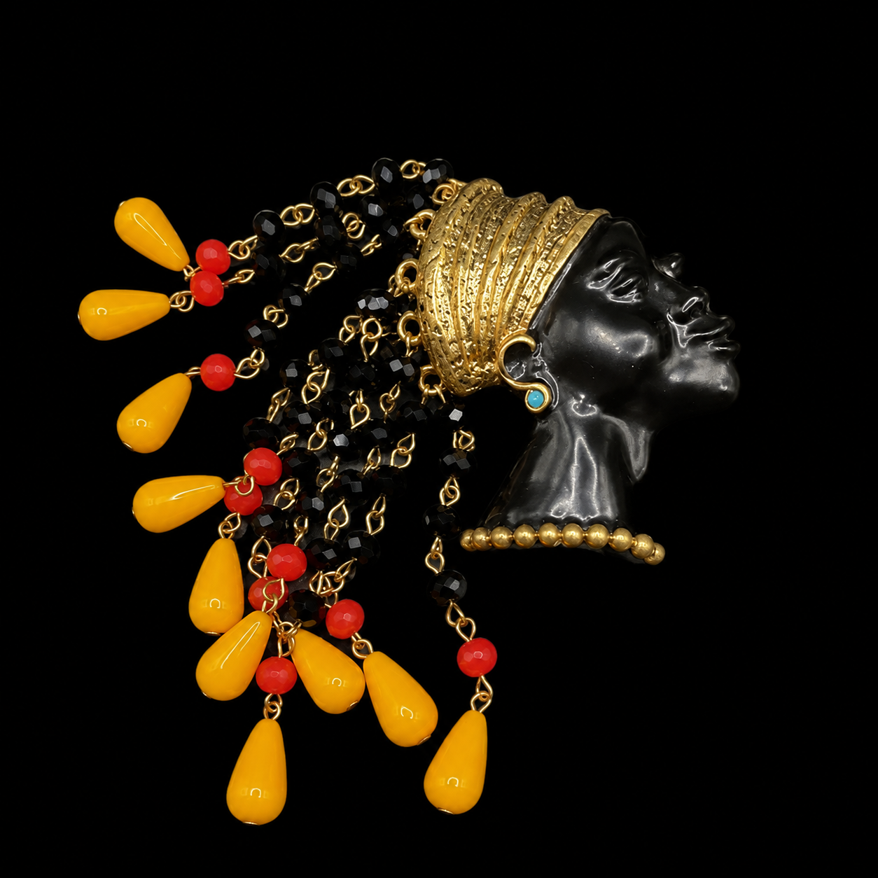 Gold-tone face tassel enamel-style resin bead brooch with yellow and red tassel beads front view