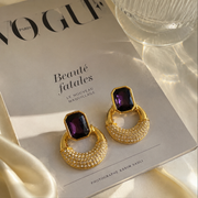 Gold-tone faceted glass crescent stud earrings in purple front view
