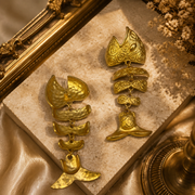 Gold-tone fish tail dangle stud earring showing front and back views with a visible stud post