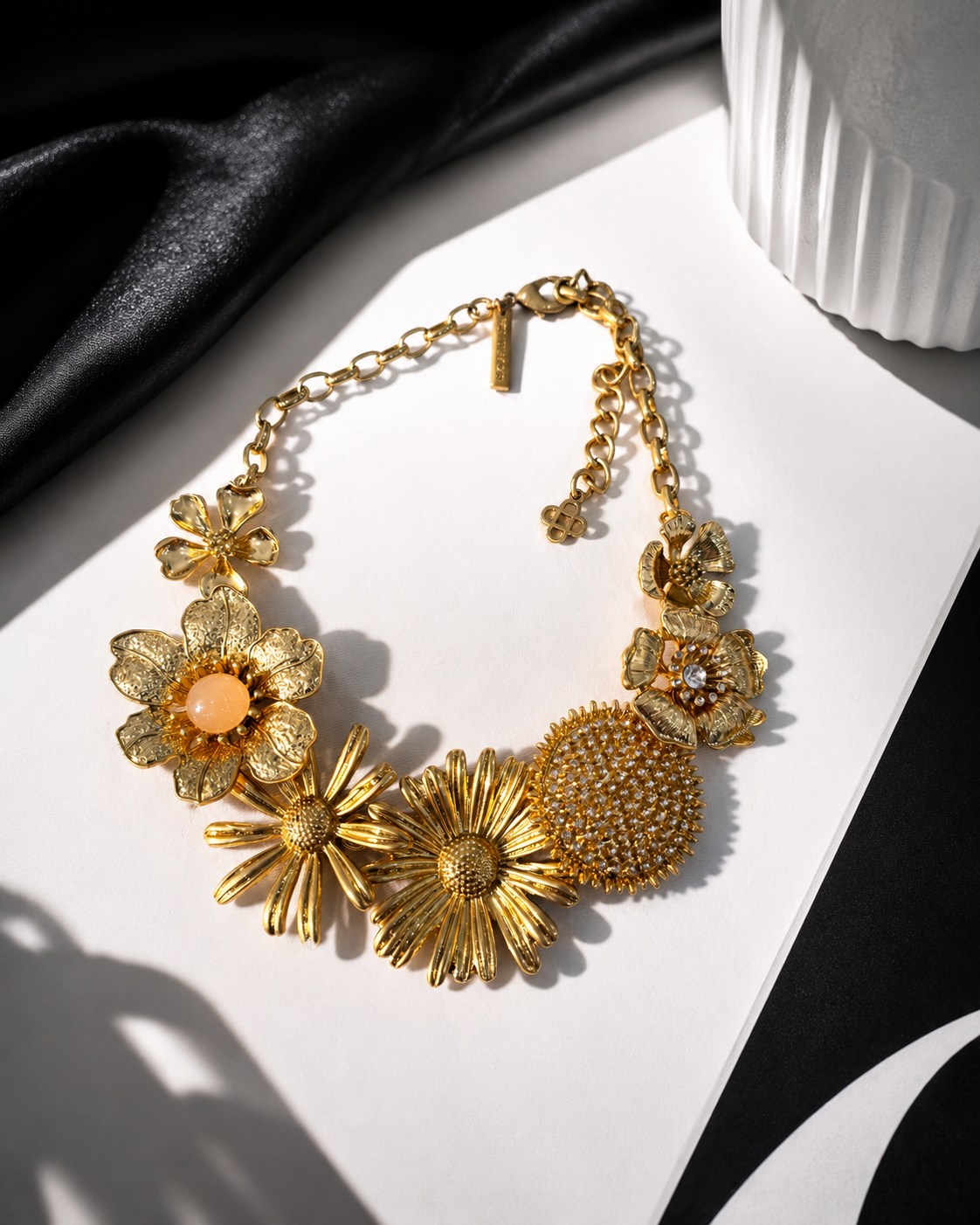 Gold-tone floral statement necklace flat lay view