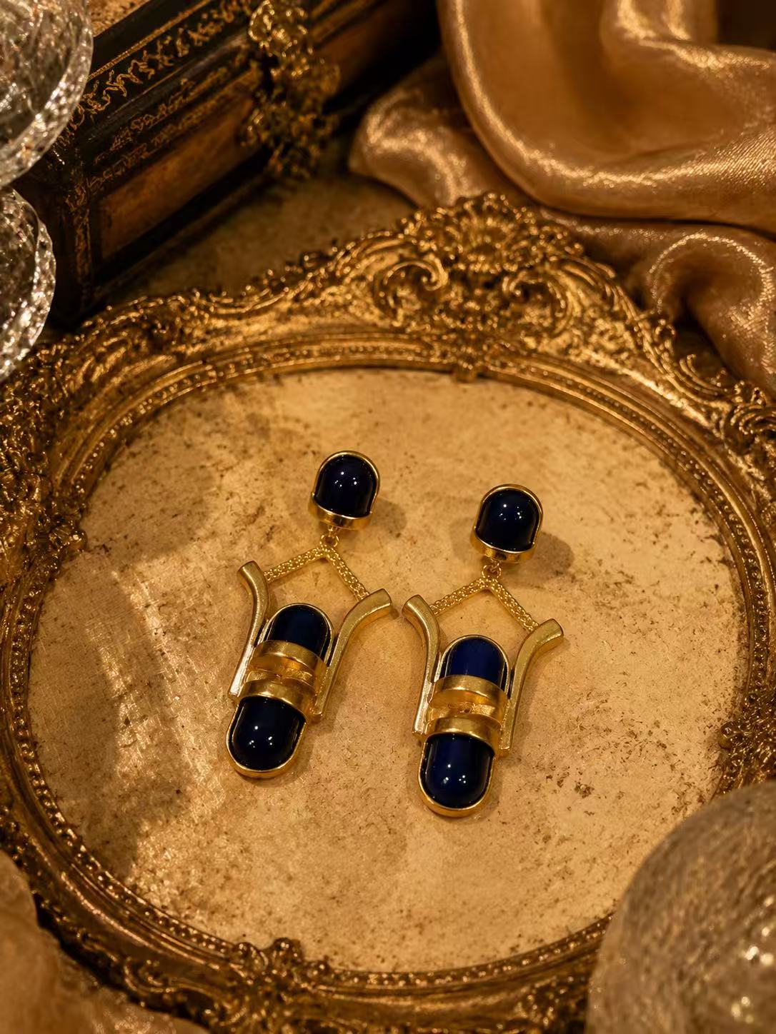Gold-tone navy blue glass-style geometric drop stud earrings
