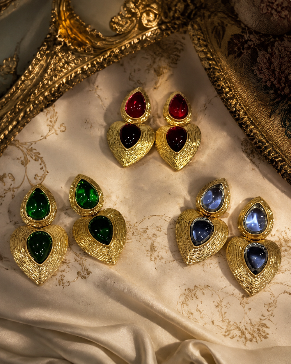 Gold-tone glass heart drop stud earrings in red, green, and light blue