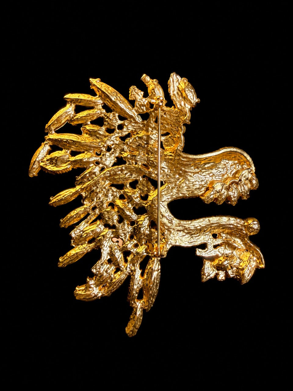 Gold-tone green crystal-style dragon head statement brooch back view with pin hardware