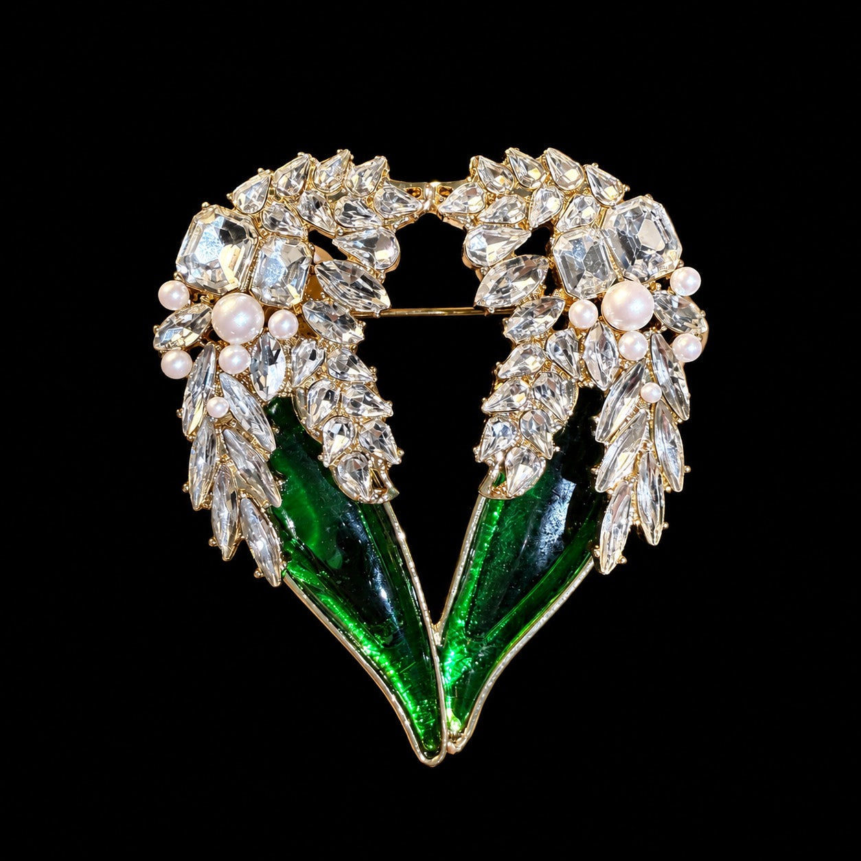 Gold-tone green crystal-style winged heart statement brooch front view