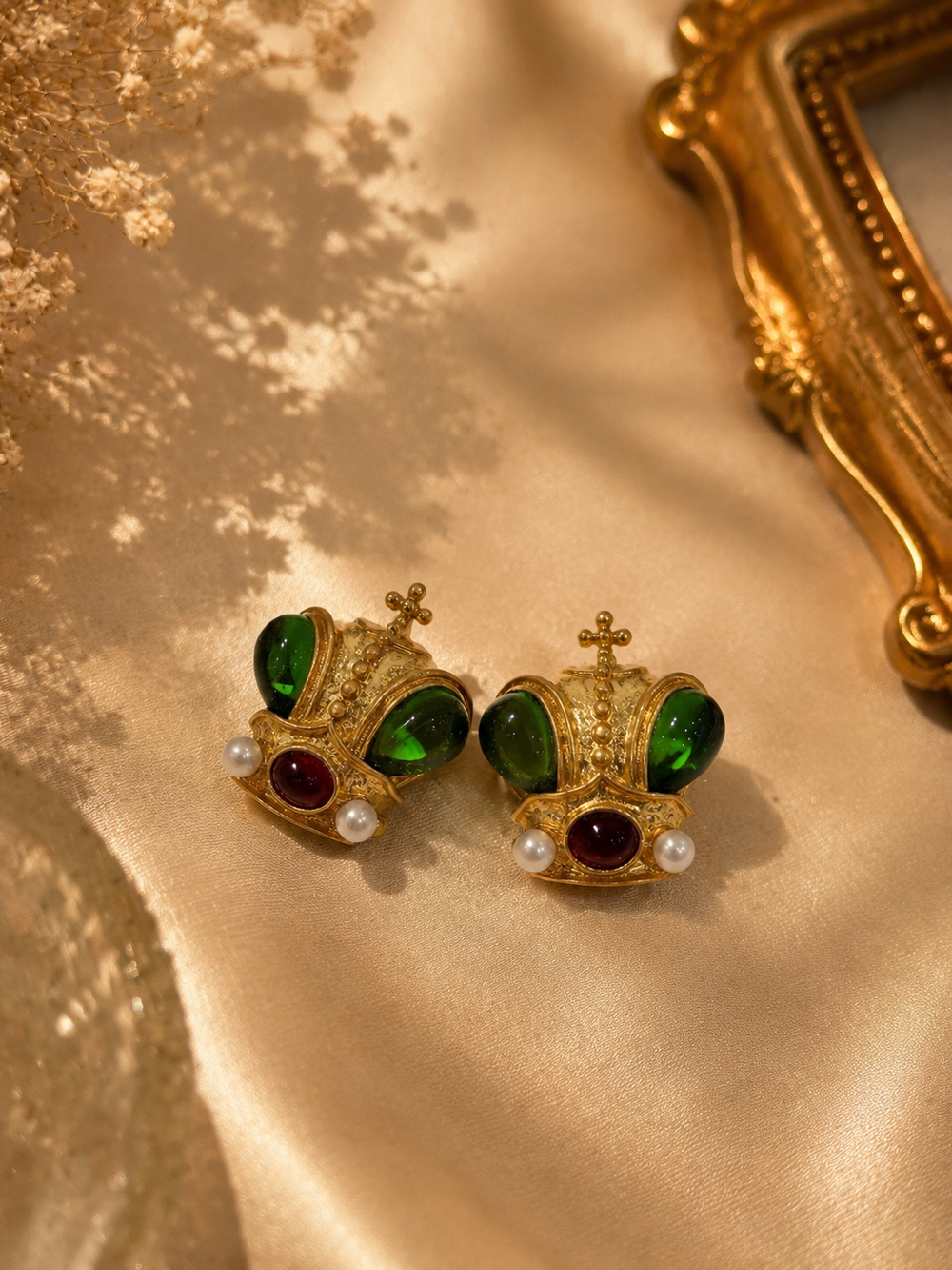 Gold-tone green glass crown stud earrings front view